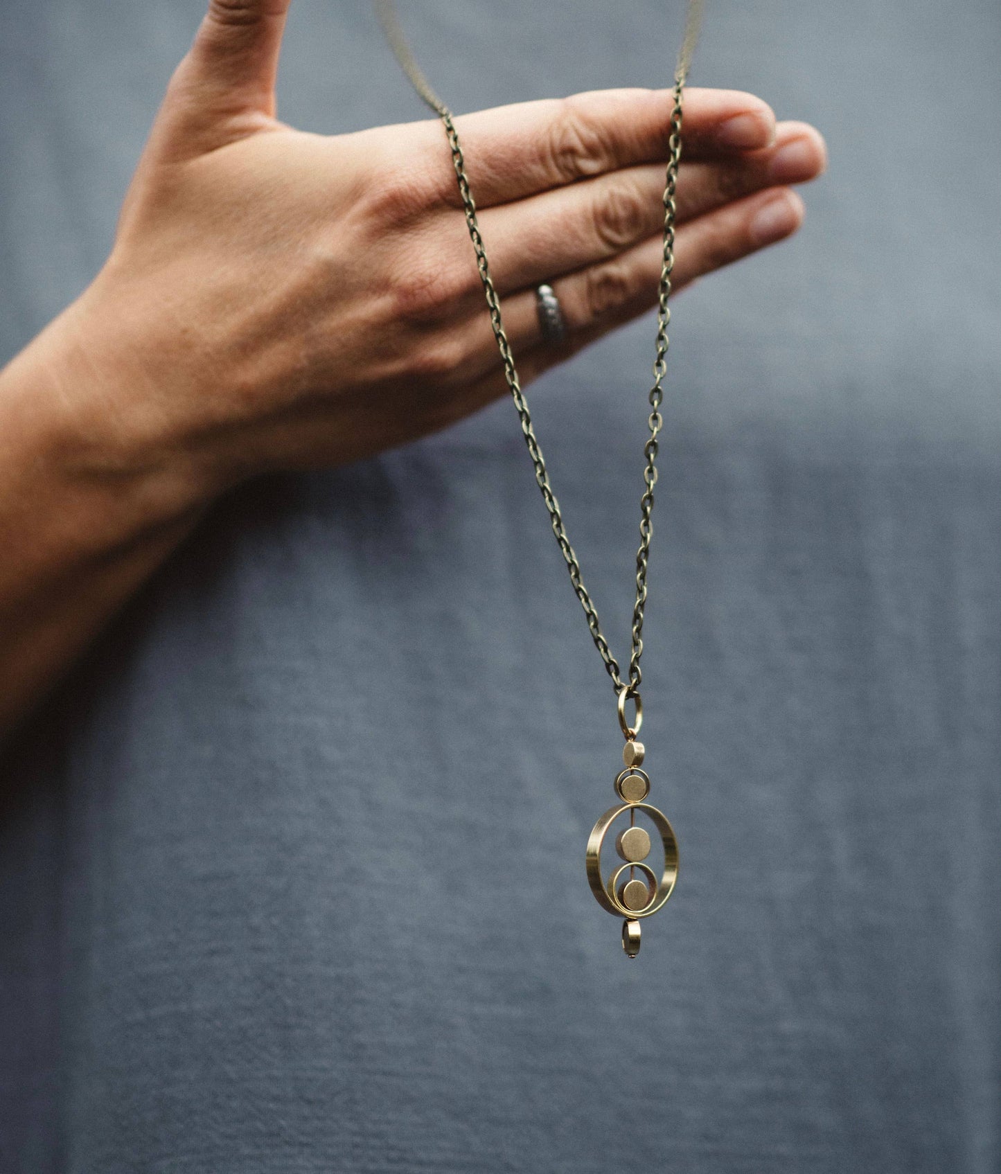 Modern Madini - Kinetic brass circle fidget necklace